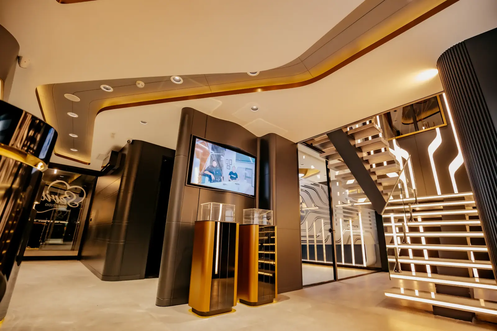 The two-storey atrium at our Istanbul clinic, with a lit staircase and reception screens