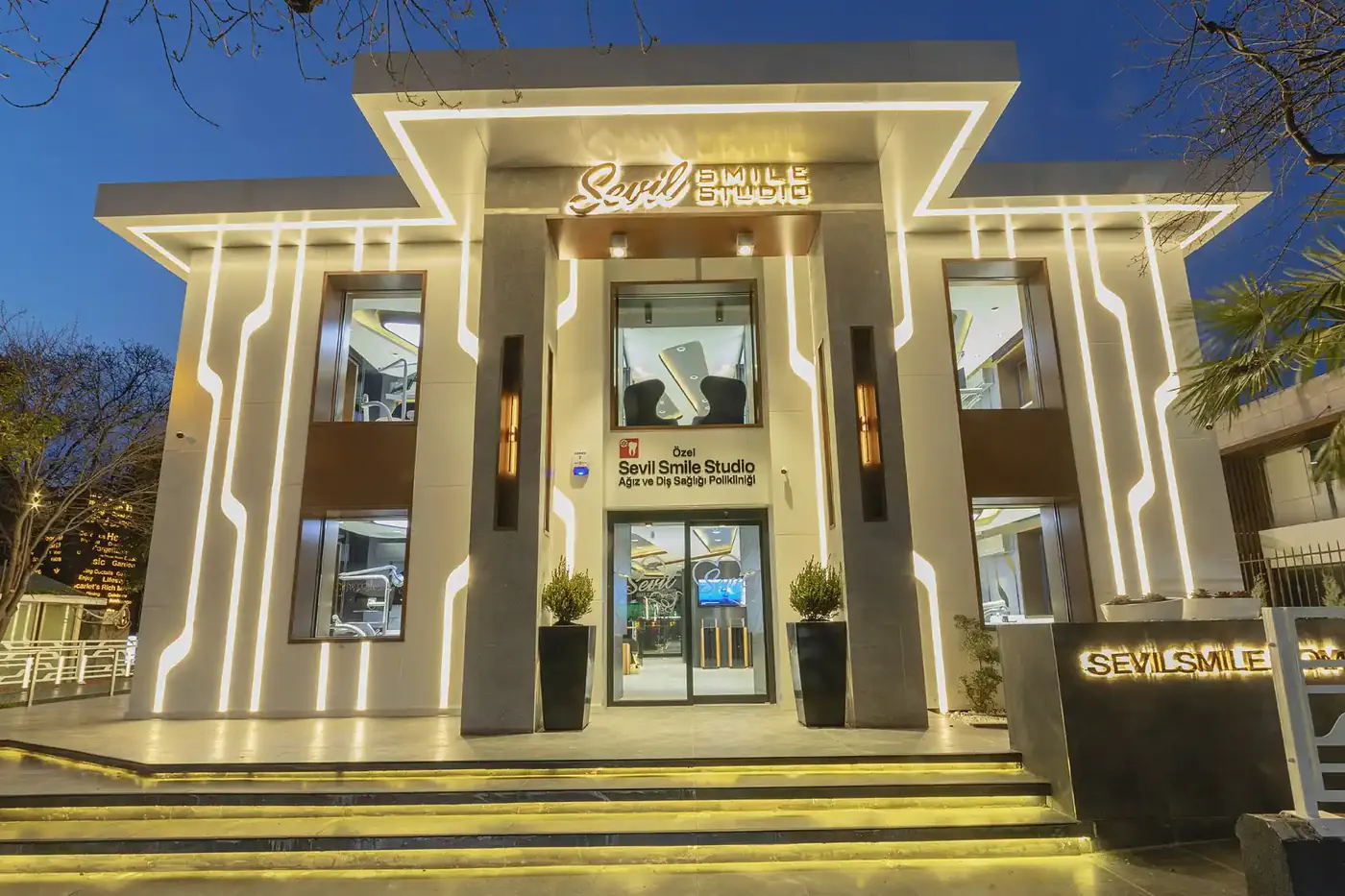 The Sevil Smile clinic building entrance in Etiler, Istanbul, lit at dusk