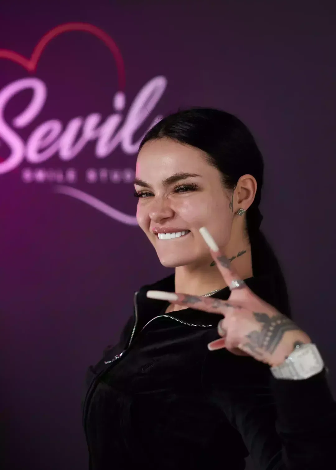 A patient smiling at the Sevil Smile Studio after her treatment